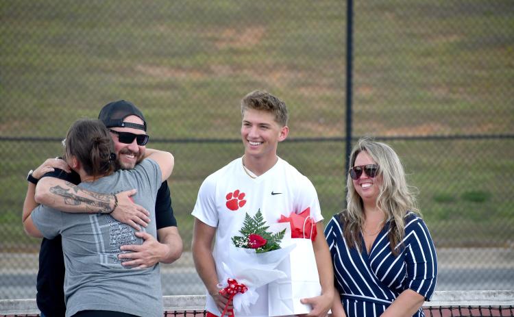 Wesley Branch/The Clayton Tribune. Rabun County senior Ashden Denning smiles as he is recognized for senior night before Rabun County’s match versus Commerce on April 2. Denning has played tennis at RCHS since his sophomore year.