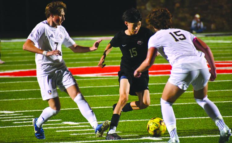 Wesley Branch/The Clayton Tribune. Rabun County sophomore Carlos Lopez-Justice navigates the White County defense in Rabun County’s 1-0 win against White County on April 3. Lopez-Justice drew multiple fouls throughout the contest, creating scoring opportunities for the Wildcats and frustrating the Warriors’ defenders.