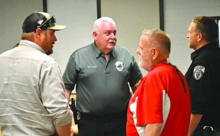 Enoch Autry/The Clayton Tribune. Newly hired Clayton Police Chief Mike Turner (center) talks with council member Channing Watts, Planning and Zoning Administrator Richard Moncus and interim Police Chief Lt. Matt Thomas at the conclusion of Tuesday’s meeting at city hall. Turner’s start date in Clayton is May 1.