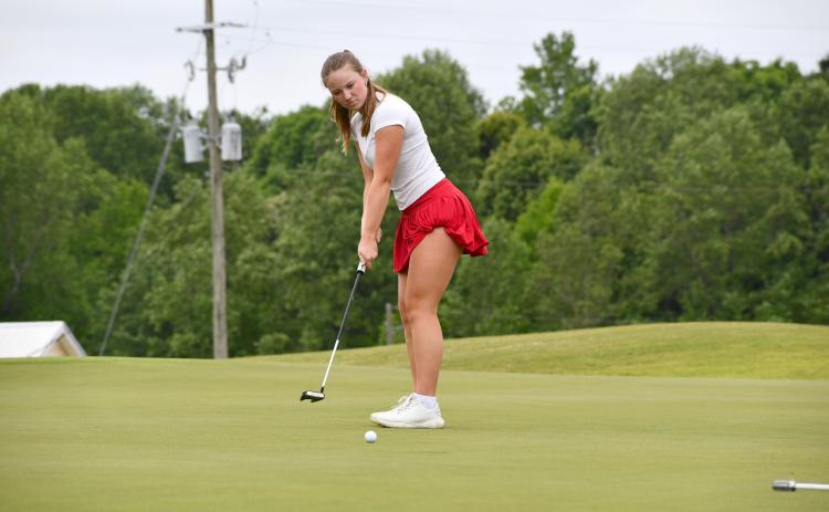 Wesley Branch/The Clayton Tribune. Rabun County sophomore Bella Hulsey watches as her putt rolls towards the hole during Rabun County’s area golf tournament at Chimney Oaks on April 27. Hulsey and the Lady Cats qualified for the state championship match for the first time since 2019.