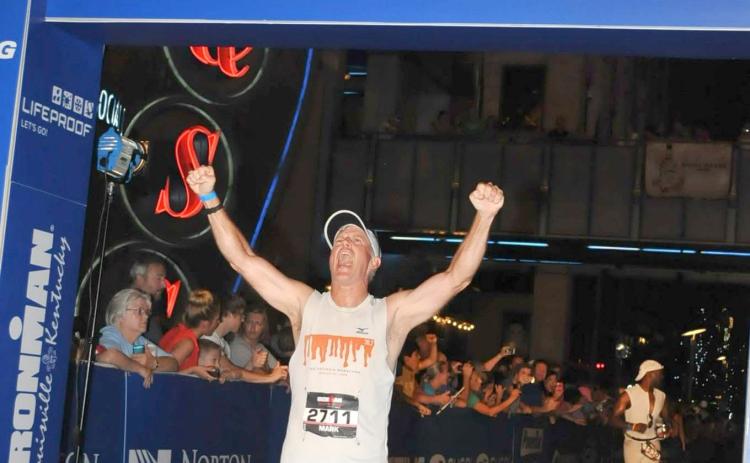 Submitted photo. Mark Holloway reacts to completing an Iron Man competition in Louisville, Ky. He will run the New River Marathon in Todd, N.C.,in May to raise up to $10,000 for Women of Worth and its first class of its recovery program.
