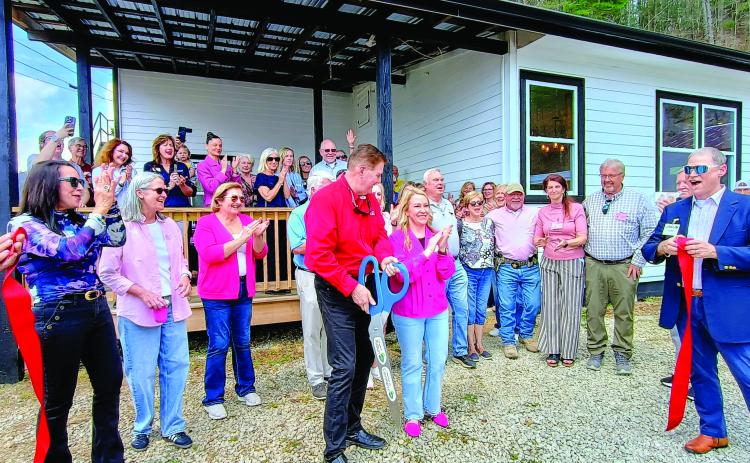 Megan Horn/The Clayton Tribune. Community members celebrate and show support on March 31 to the nonprofit Women of Worth (WOW) Recovery as the ribbon is cut on the first residential substance-abuse recovery center in Rabun County. Forward Rabun/Rabun County Chamber of Commerce held an official ribbon cutting and grand opening celebration. It is located at 5989 Highway 441, Lakemont, and can be reached by telephone by contacting 706-782-9761.