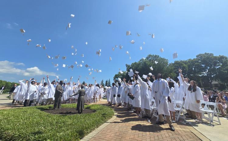 Enoch Autry/The Clayton Tribune.  A record number of seniors graduate during the morning of Sunday, May 17, at the Rabun Gap-Nacoochee School as 107 toss their caps into the air in celebration. 