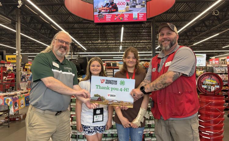 Photo courtesy of Rabun County 4-H. Rabun County 4-H Educator Joey Eller receives a gift card from Clayton Tractor Supply Company Manager Ricky Albright, as 4-H’ers Maleigha Beck and Karsen Pendrey observe.