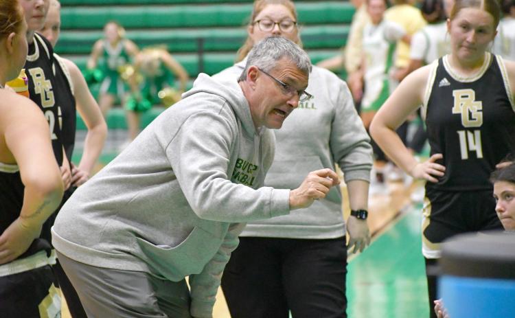 Wesley Branch/The Clayton Tribune. RGNS head girls basketball coach Dale Earnhardt directs his team during a timeout against Buford.