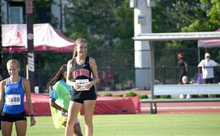 Wesley Branch/The Clayton Tribune. Rabun County freshman Kinley Jones smiles after receiving her medal for finishing seventh place in the 3200 meter race at the GHSA state championship meet on May 12 in Athens.