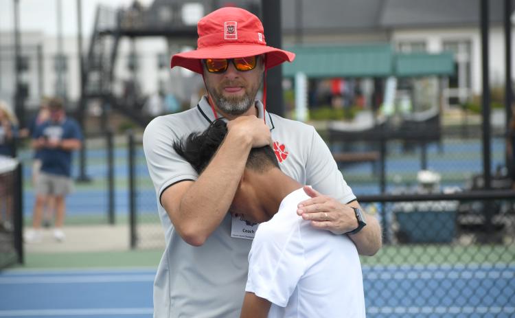 Wesley Branch/The Clayton Tribune. Rabun County head tennis coach Bryan Getty consoles his son and RCHS tennis freshman Jack Getty after the Wildcats’ loss to Brantley County in the state championship game on May 13 at the Rome Tennis Center. Getty played No. 2 singles for the Wildcats this season .