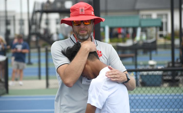 Wesley Branch/The Clayton Tribune. Rabun County head tennis coach Bryan Getty consoles his son and RCHS tennis freshman Jack Getty after the Wildcats’ loss to Brantley County in the state championship game on May 13 at the Rome Tennis Center. Getty played No. 2 singles for the Wildcats this season .