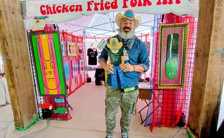 Megan Horn/The Clayton Tribune. Chris Allison features his Chicken Fried Folk Art at last weekend’s Dingerfest event held at the pavilions in downtown Clayton.