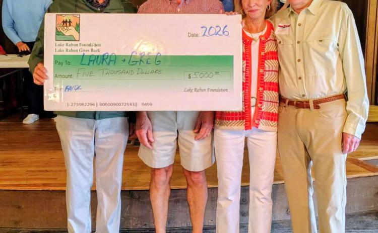 Megan Horn/The Clayton Tribune. Greg and Laura Rhodes are recipients of the 2026 Buz Stone “Lake Rabun Cares” Award. They were awarded the honor during the May 24 Lake Rabun Association annual meeting on Memorial Day weekend May 24. Pictured are Buz Stone, after whom the award is named, Greg Rhodes, Laura Rhodes and Steve Raeber, executive director of the Lake Rabun Foundation. 