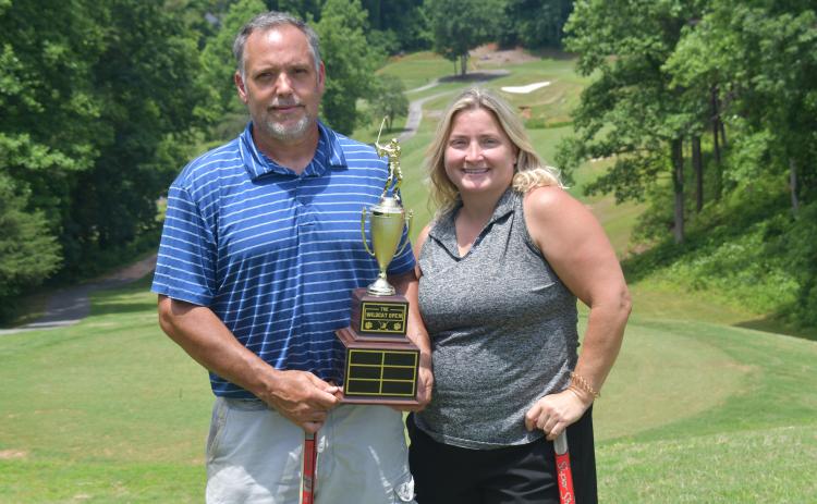 Wesley Branch/The Clayton Tribune. Jamie Smith (right) and Jason Murphy pose with the Wildcat Open trophy after winning the inaugural Wildcat Open Tournament on June 5 at Kingwood Golf Club. Smith and Murphy will have their names and score placed on the trophy, which will be displayed on RCHS’ campus. 
