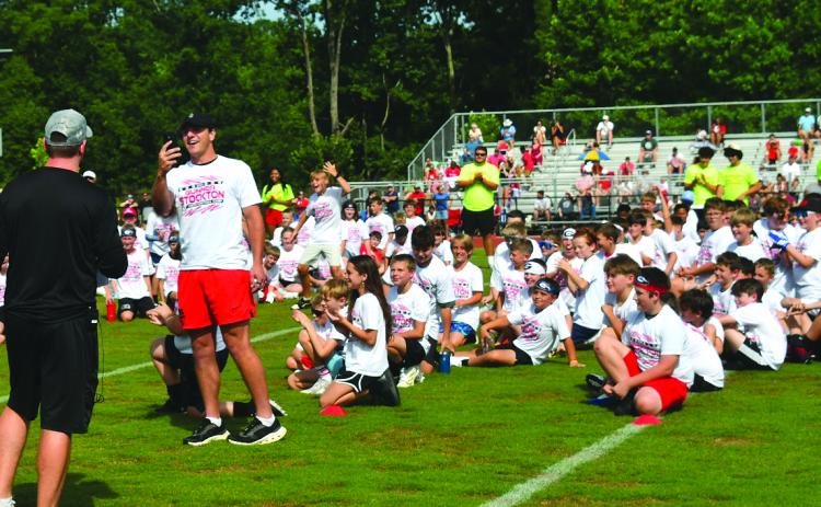 Enoch Autry/The Clayton Tribune. Former Rabun County standout and current University of Georgia quarterback Gunner Stockton takes a selfie with youth participants of the Gunner Stockton Football Camp sitting on the field at Lakeview Academy on June 20 in the background. This is the camp’s second year.