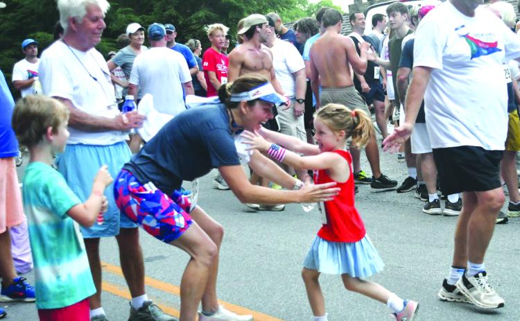 File/Enoch Autry/The Clayton Tribune. At last year’s Rabun Ramble, 5-year-old Carver Harris, runs toward the awaiting arms of her mother Courtney Harris following their 5K runs at the event in Lakemont. This year’s Rabun Ramble will be Saturday, July 4.