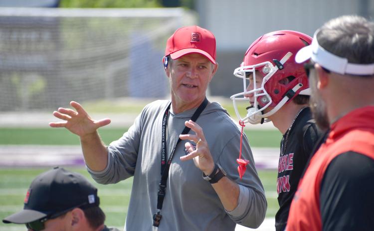Wesley Branch/The Clayton Tribune. Rabun County head football coach Rance Gillepsie (left) talks with Colter Cannon (middle right) during the Wildcats’ 7-on–7 versus Lumpkin County and Union County on June 11 at Union County High School. Gillespie is entering his second season as the head coach of RCHS. 
