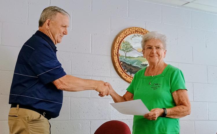 Megan Horn/The Clayton Tribune. Mountain City Mayor Grace Watts, right, shakes hands and congratulates C.L. Faulkenberry as the newest council member on June 9. 