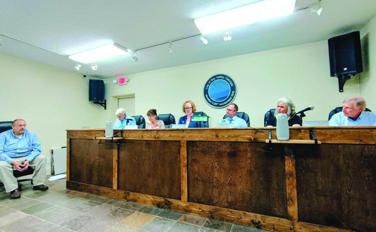 Megan Horn/The Clayton Tribune. Sky Valley city council members vote Tuesday, June 16, to accept the resignation of City Manager Jason Streetman (far left). Mayor Benita Cotton-Orr reads aloud a city news release while council members Tony Allred, Beth Pence, Jesse Price and Jim Curtis approve the resignation. Council Member CareySue Beasley recused herself from the vote. 