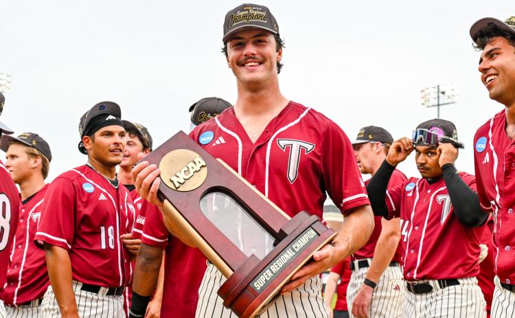 Aliza Chambers/Troy University. Rabun Gap alumnus Dylan Alonso holds the trophy after he and the Trojans won an NCAA Super Regional this postseason for the first time in program history. Following his best collegiate season, Alonso was selected in the 16th round of the MLB Draft by the Kansas City Royals. 