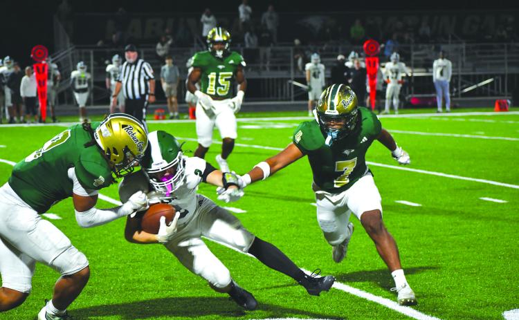 Wesley Branch/The Clayton Tribune. Rabun Gap linebackers Kaylan Brown (left) and Praise Chane (right) close in on a Christ School ball carrier in the Eagles’ 42-0 regular season win over the Greenies on Oct. 17, 2025. Brown announced his commitment to East Tennessee State last week and Chane announced his commitment to Navy.