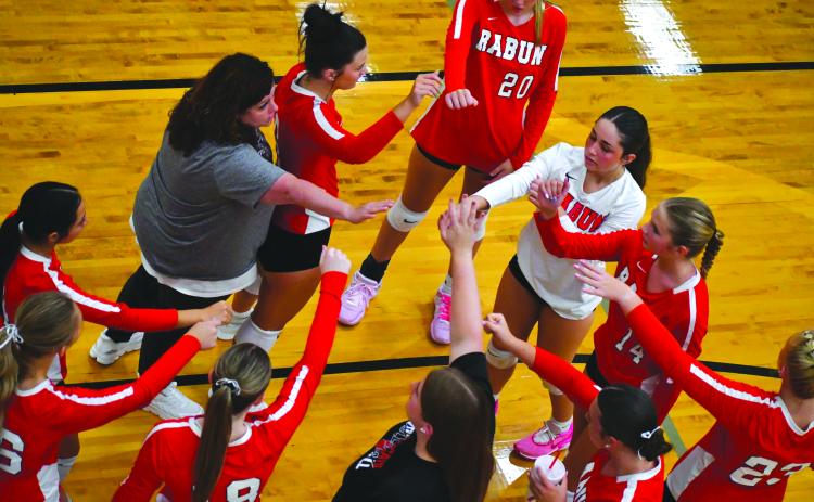 Enoch Autry/The Clayton Tribune. Rabun County Head Coach April Jones, left, connects with her volleyball players in 2025 during a home game early in the season.