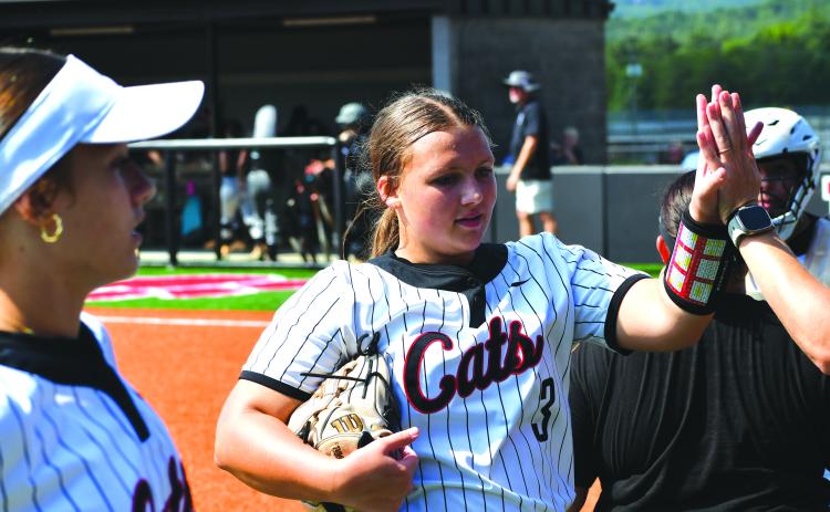 Wesley Branch/The Clayton Tribune. Rabun County’s Jaylynn Gragg receives a high five after completing an inning in the Lady Cats’ 20-3 win over Tallulah Falls on Aug. 16, 2025. Gragg will be one of four potential starting pitchers for RCHS this upcoming season. 