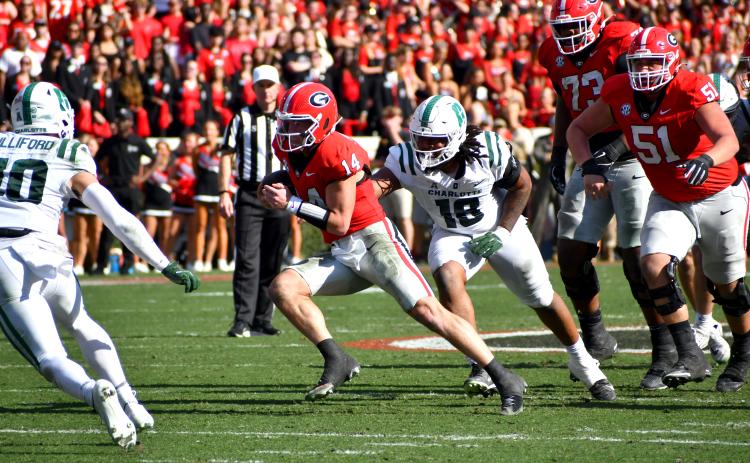 Wesley Branch/ The Clayton Tribune. Current UGA and former Rabun County quarterback Gunner Stockton evades defenders during Georgia’s 35-3 win over Charlotte on Nov. 22, 2025. Stockton is entering year two as Georgia’s starting quarterback.