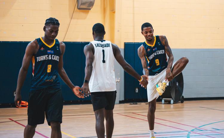 Submitted photo. Recent Rabun Gap graduate RJ Lacossade (center) high fives teammates during a practice with the Turks & Caicos national team in preparation for the 2029 FIBA AmeriCup Caribbean Pre-Qualifiers. Lacossade, who is signed with Southern Wesleyan University, was born in Turks & Caicos and left his home country at the age 14 to chase his basketball dreams. 