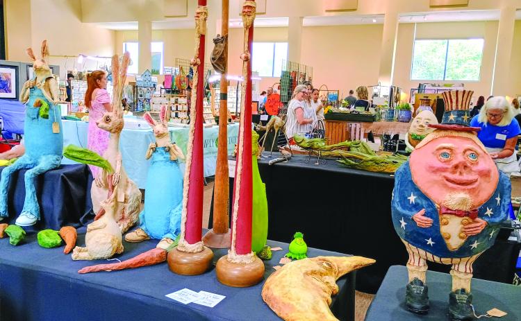 Megan Horn/The Clayton Tribune. Paper mache artist Judy Schmidt with her “Paper Trails” is this year’s winner of the Painted Fern Art Festival “Peoples’ Choice Award for Best in Show.” Her booth featured many of her paper mache characters including cartoon character “Humpty Dumpty,” a crescent moon, rabbits and many others.