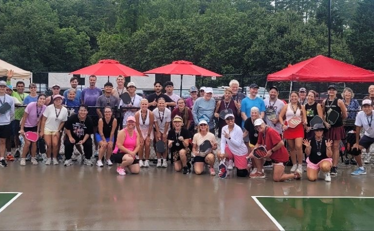 Submitted. Dozens of pickleball players from Rabun County and surrounding communities braved the showers to compete in a Team Challenge tournament on Saturday, July 25. The players and spectators contributed $1,000 to the Sid Weber Cancer Fund from the pickleball fundraiser. The pickleball courts on the Rabun County Recreation Department property in Tiger have been used extensively since their opening.