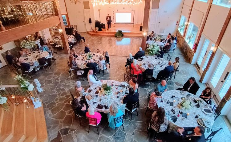 Megan Horn/The Clayton Tribune. Aaron Hooker plays a worship set during the Choices Pregnancy Center Heartbeat Gala on Aug. 1 at Chota Falls. Gala guests sang along and praised God with hands in the air. The venue was beautifully lit and decorated. 