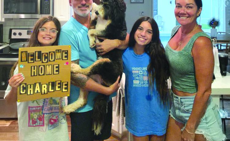Submitted photo. The Orozcos -- Isabelle, Adrian, Juliana, Chelsea -- are very happy to have Charlee, a 2-year-old Bernadoodle, back with the family after a self-led tour of Rabun County.