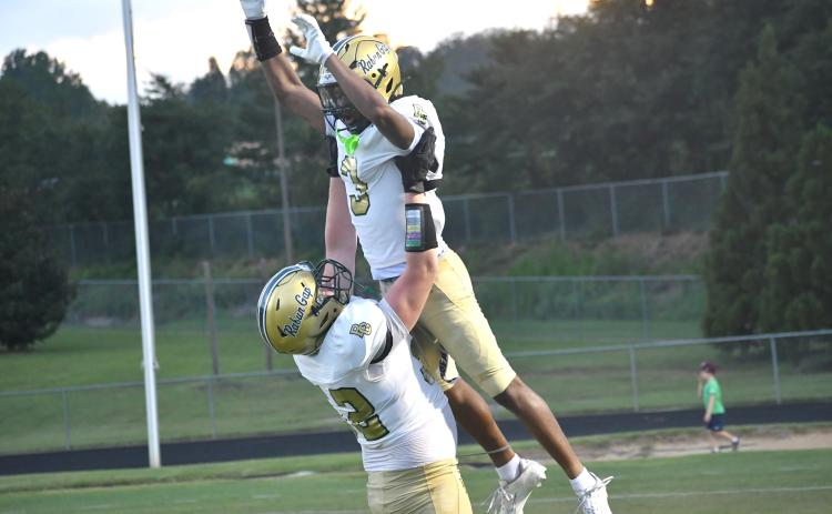 Wesley Branch/The Clayton Tribune. Rabun Gap offensive lineman Wilder Brasher lifts wide receiver Joshua Davis in the air in celebration after Davis’ 60-yard touchdown reception during Rabun Gap’s scrimmage versus Westside (S.C.) on Aug. 14. Davis’ long touchdown grab from quarterback Grayson Clary tied the scrimmage, 13-13.