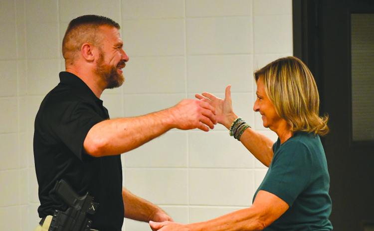 Enoch Autry/The Clayton Tribune. Clayton City Manager Trudy Crunkleton (right) prepares to give Kevin Marsteller a hug after the city council unanimously approved the current major with the Corneila Police Department as Clayton’s new police chief. Marsteller will succeed Michael Turner, who has announced his resignation effective Aug. 28.