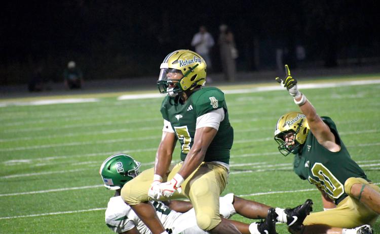 Wesley Branch/The Clayton Tribune. Rabun Gap linebacker Praise Chane (center) celebrates after making a tackle for a loss on third down during Rabun Gap’s 42-40 overtime loss on Aug. 21. Chane, a senior, is committed to the Naval Academy.