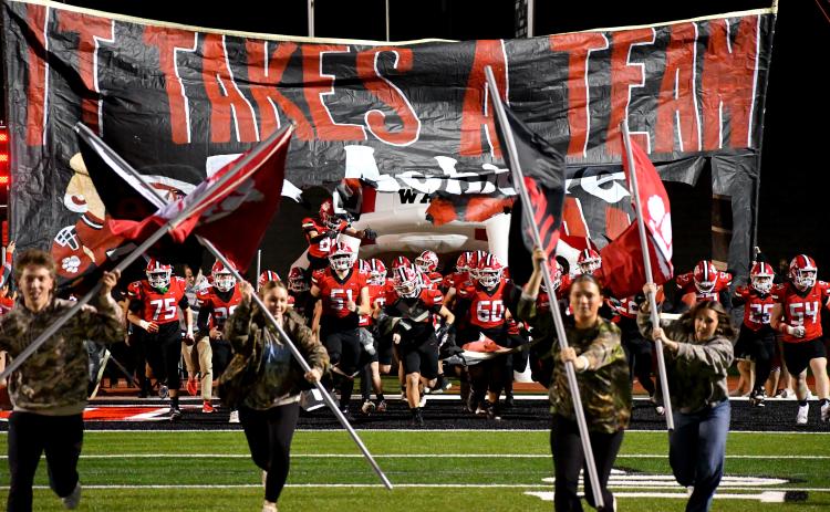 Wesley Branch/The Clayton Tribune. Rabun County High School’s football team runs onto the field before its second-round playoff game versus Berrien last season. The Wildcats enter 2026 following a 10-3 record and run to the state quarterfinals a season ago.