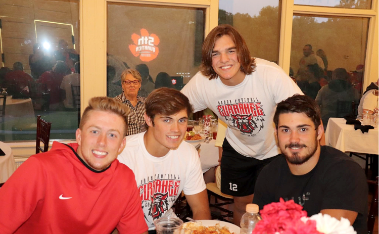 Photo courtesy Von Watts. From left, Braxton Hicks, Hoff Windham, Gunner Stockton and Mason Sprinkle pose for a photo during an episode of the “Fifth Quarter Show” at Mama G’s Italian Restaurant. The show was first held at Mama G’s before being moved to Wildcat Grill years later. 