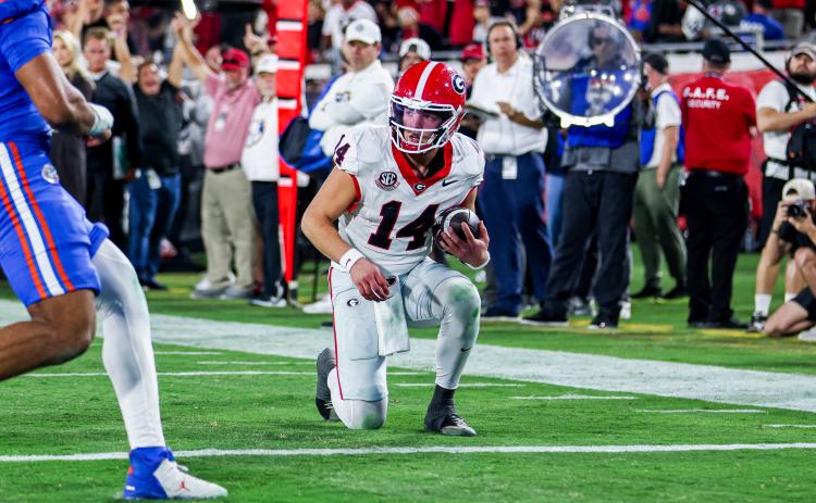Photo courtesy UGAAA. Georgia quarterback Gunner Stockton takes a knee to preserve a 24-20 win on Nov. 1, 2025, for the Dawgs over Florida by running out the clock.