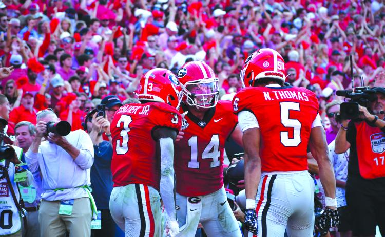 Photography by Wesley Branch/The Clayton Tribune. Former Rabun County and current UGA quarterback Gunner Stockton celebrates with teammates Nate Frazier Jr. (left) and Noah Thomas (right) after scoring a rushing touchdown during Georgia’s 43-35 win over Ole Miss at Sanford Stadium on Oct. 18, 2025. Stockton is heading into his final season of college football and his second season as Georgia’s starting QB