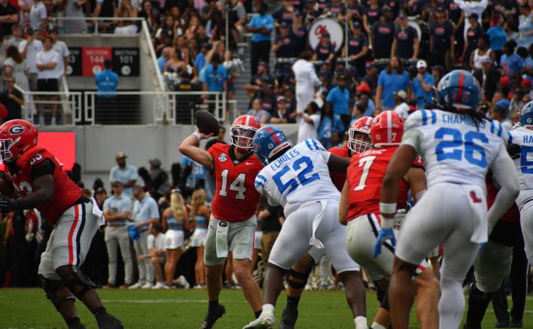 Wesley Branch/The Clayton Tribune. Former Rabun County standout and current Georgia starting quarterback Gunner Stockton prepares to release his pass around Ole Miss defensive lineman Will Echoles Sanford Stadium on Oct. 18, 2025.