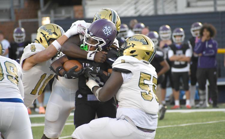 Wesley Branch/The Clayton Tribune. The Rabun Gap defense brings down Ambassador Christian School running back Ezekiel Kelly during its 31-6 win over the Lions on Sept. 25. RGNS’ defense forced three turnovers in the victory.