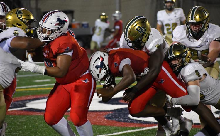 Wesley Branch/The Clayton Tribune. Providence Day quarterback Zaid Lott is tackled by a pair of Rabun Gap defenders during the Sept. 19, 2025, between the foes. This year Eagles and Chargers play at Rabun Gap on Sept. 18 with a 7 p.m. kickoff.