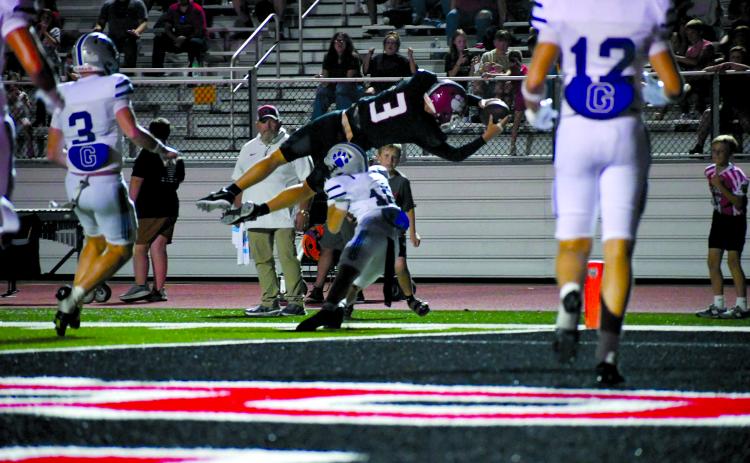 Enoch Autry/The Clayton Tribune. Rabun County quarterback Cooper Kowalsky goes airborne at the goal line to pick up extra yardage against Gilmer on Sept. 18. Kowalsky would come up just short of the end zone and running back JK Fruster would punch it in for the score on the ensuing play in the Wildcats’ 53-52 overtime loss. 