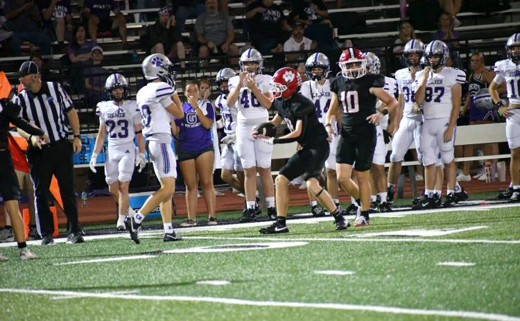 Enoch Autry/The Clayton Tribune.  RCHS free safety Colter Cannon shows the ball to the officials on a play the referees would call a catch by Gilmer receiver Mason West (10). Video and photographic evidence would dispute the catch. Gilmer would be credited with a first down on the fourth down play and would then kick a game-typing field goal in regulation. In overtime, Gilmer would win on a touchdown and 2-point conversion. 
