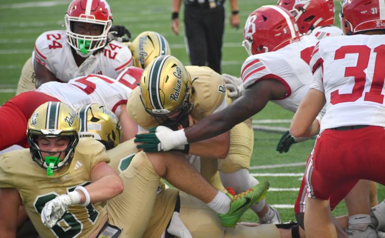 Wesley Branch/The Clayton Tribune.  Rabun Gap quarterback Grayson Clary (center) pushes forward for a touchdown on a quarterback sneak in Rabun Gap’s 51-33 Sept. 4 loss to Baylor. Clary and the Eagles are still searching for their first win of the new season.