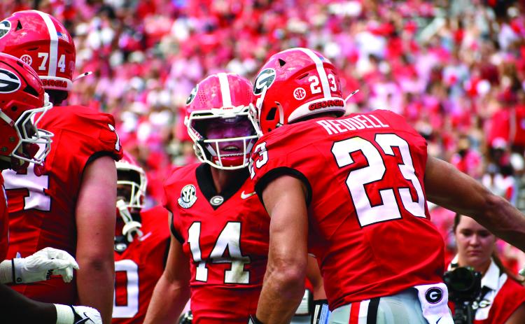 Wesley Branch/The Clayton Tribune. Former Rabun County and current UGA quarterback Gunner Stockton (center) celebrates with teammate Jaden Reddell after the duo connect for a touchdown in Georgia’s 63-3 Sept. 5 win over Tennessee State. Stockton and the Bulldogs will host Western Kentucky on Sept. 12.