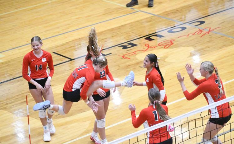 Wesley Branch/The Clayton Tribune. Rabun County volleyball players celebrate during their home match versus East Hall on Sept. 8. The Lady Cats were victorious in the match 2-0, winning by scores of 25-21 and 25-19.