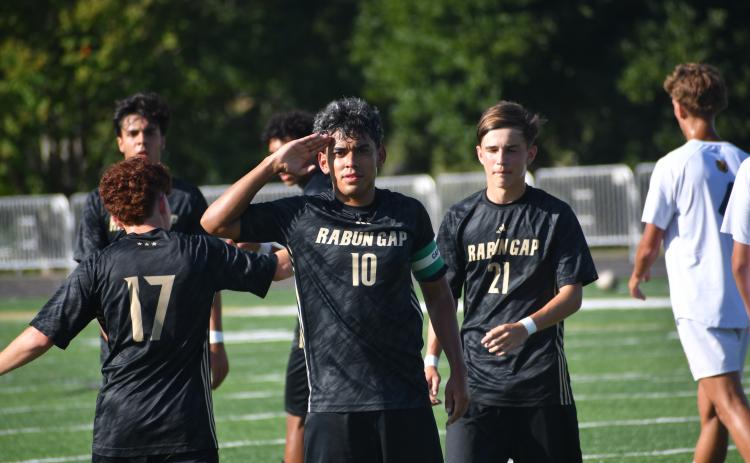 Wesley Branch/The Clayton Tribune.  Rabun Gap senior and captain Jose Luis Carrillo salutes after scoring versus ACA in the Eagles’ 3-0 win over the Lions on Sept. 9. Carillo’s hat trick on Sept. 12 helped lead Rabun Gap past Winston Salem Christian, 5-4.