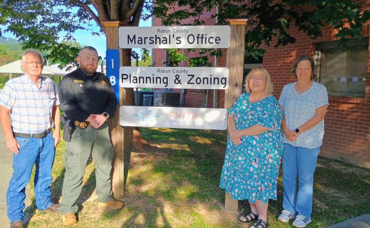 Megan Horn/The Clayton Tribune. The Rabun County Marshal’s Office serves as the code enforcement officer by enforcing county ordinances and state laws. The office is responsible for Planning and Zoning and also oversees county probation officers. Pictured are Planning and Zoning Administrator Tommy York, Rabun County Marshal David Gerrells, Lynne Ramey and Administrative Assistant Lisa Gibson.