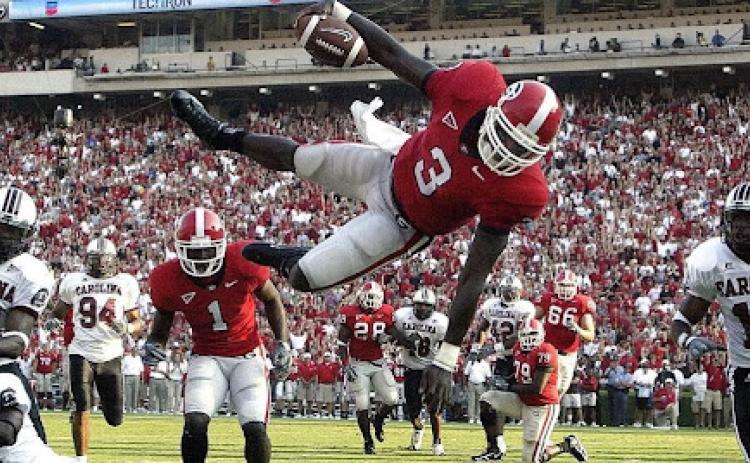 Photo courtesy of DJ Shockley. Former UGA quarterback DJ Shockley goes airborne on a run versus South Carolina during his playing days. Shockley, now a sports anchor with Fox 5 Atlanta, was Georgia’s starter in 2005. 