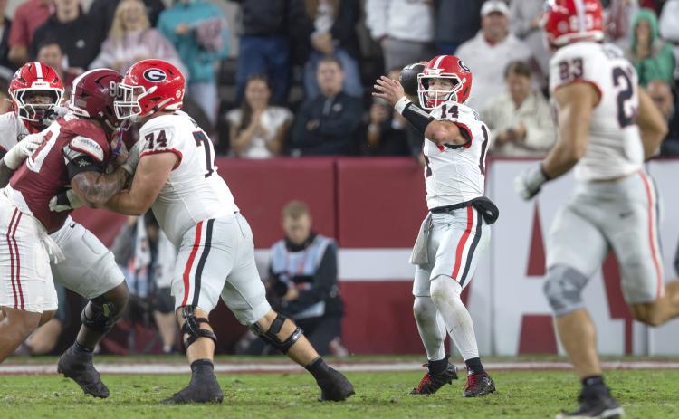 Photo via Ken Ward/DawgTime. UGA and former Rabun County quarterback Gunner Stockton releases a pass downfield during Georgia’s 20-17 win versus Alabama on Oct. 17. Stockton scored two total touchdowns and had 261 total yards.