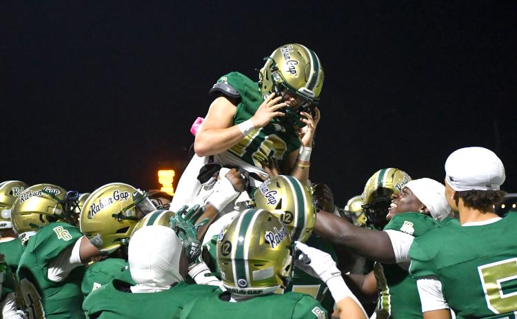 Wesley Branch/The Clayton Tribune. Rabun Gap players lift Hector Nahle (center) into the air after Nahle scores a touchdown in RGNS’ 42-0 win versus Christ School in 2025. Nahle was a backup quarterback for two years before transitioning to receiver